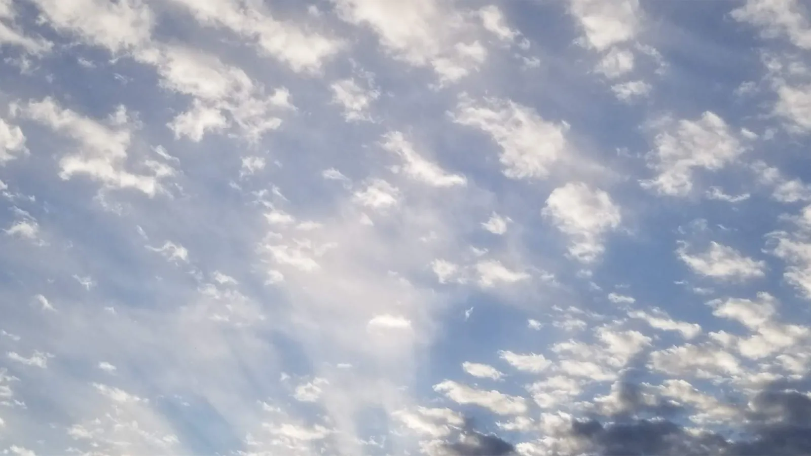 Blue sky with rolling clouds.
