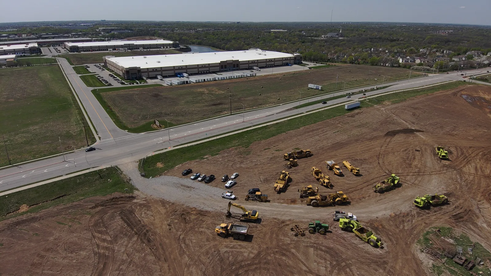 Aerial view of road, warehouse and construction machinery 