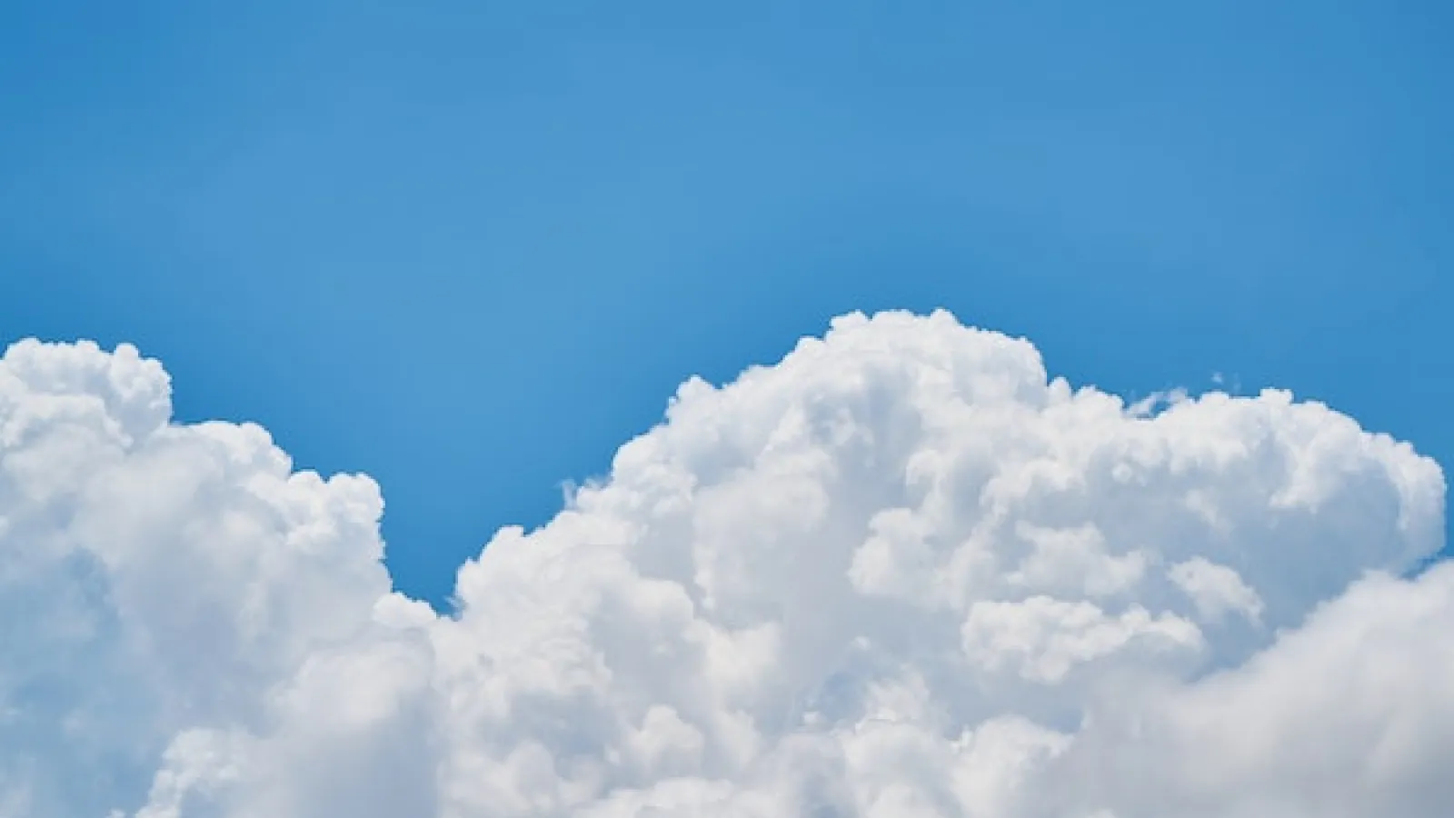 Puffy cloud and blue skies