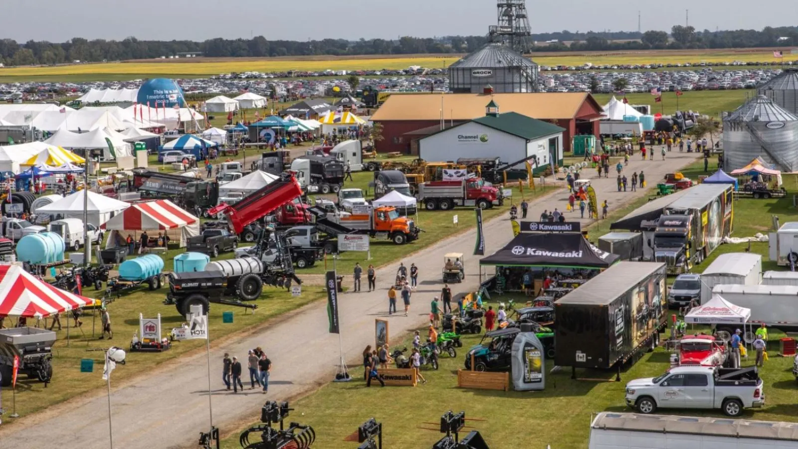 CFAES Farm Science Review - Fair scene with tents and trucks and equipment spread around an open field.