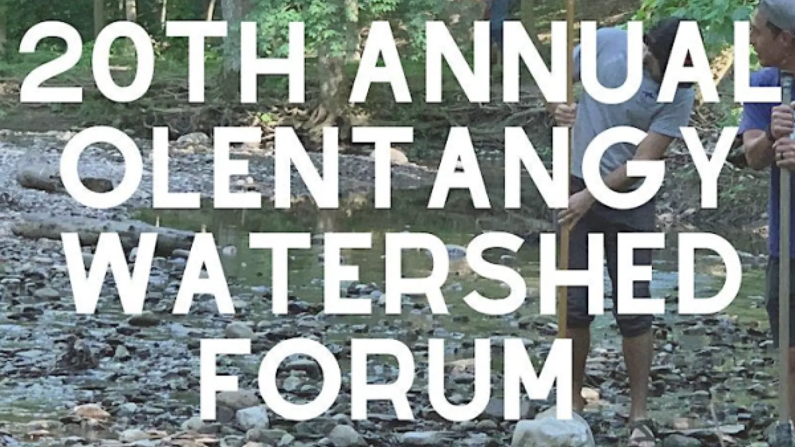 Rock-covered riverbank with white text, 20th annual Olentangy Watershed Forum. 