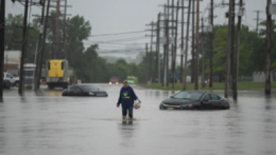 Person walking in a flooded street.