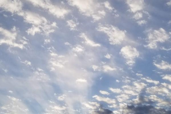 Blue sky with rolling clouds.