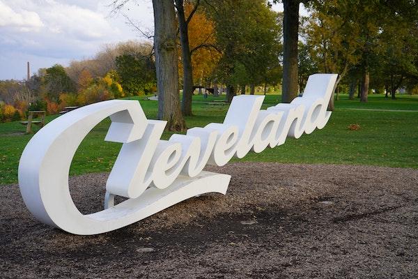 White Cleveland Script Sign in a Park